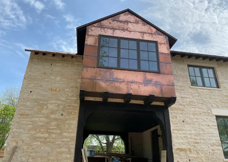 Copper metal panel facade on a stone building for Skylight Installation in Altadena